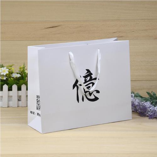 定制服装专卖店手提袋产品广告宣传纸袋250克白卡纸彩印